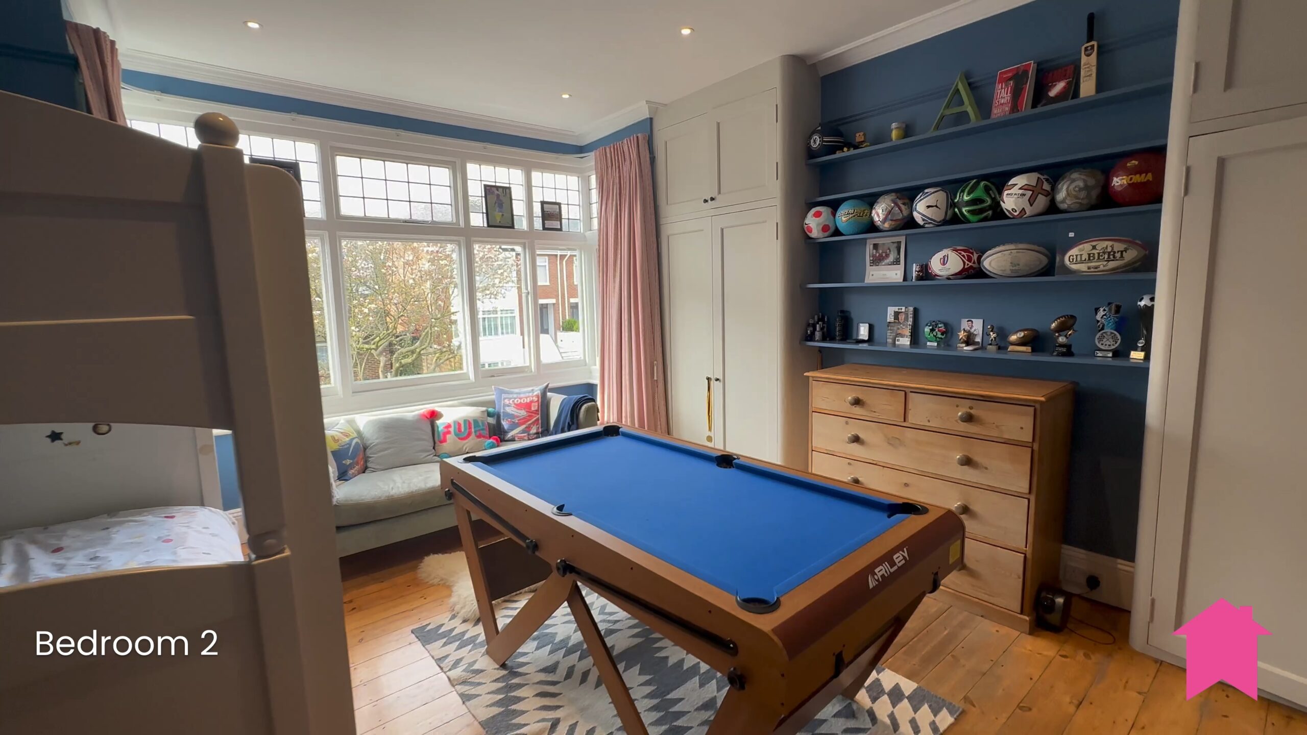 A high-resolution picture of a living room with a pool table taken on the Prevue app